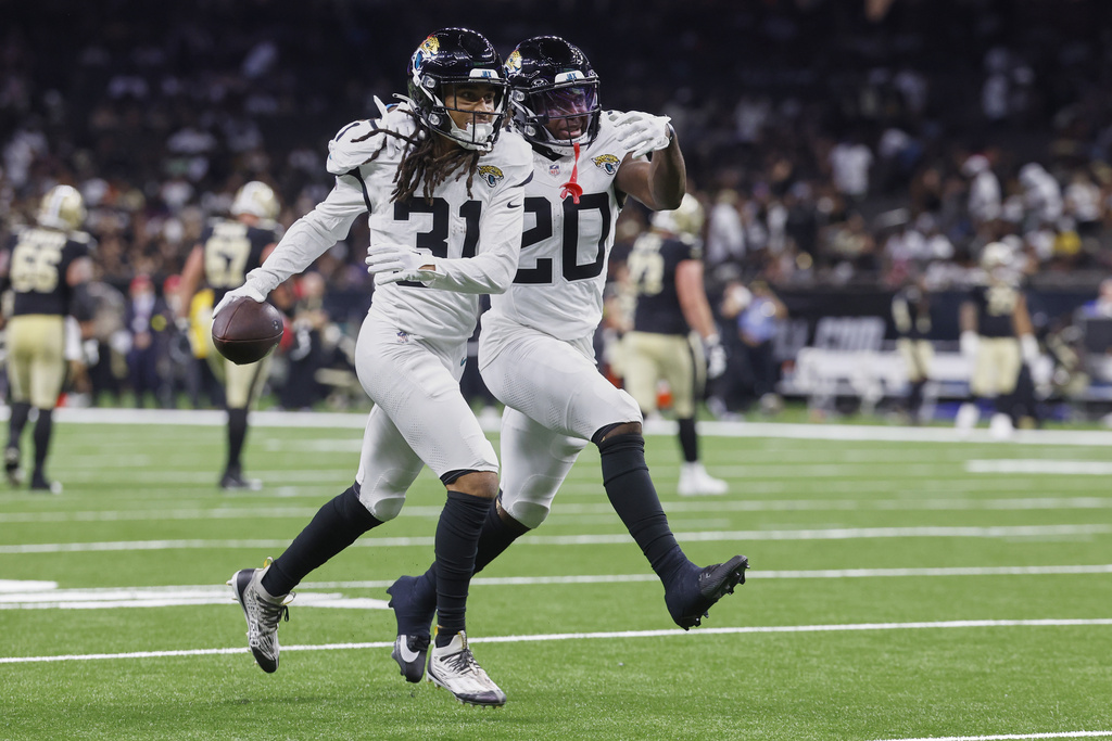 Jacksonville Jaguars cornerback Keni-H Lovely (31) celebrates a pass interception against the New Orleans Saints with safety Daniel Thomas (20) in the second half of an NFL preseason football game in New Orleans, Sunday, Aug. 17, 2025. (AP Photo/Butch Dill)