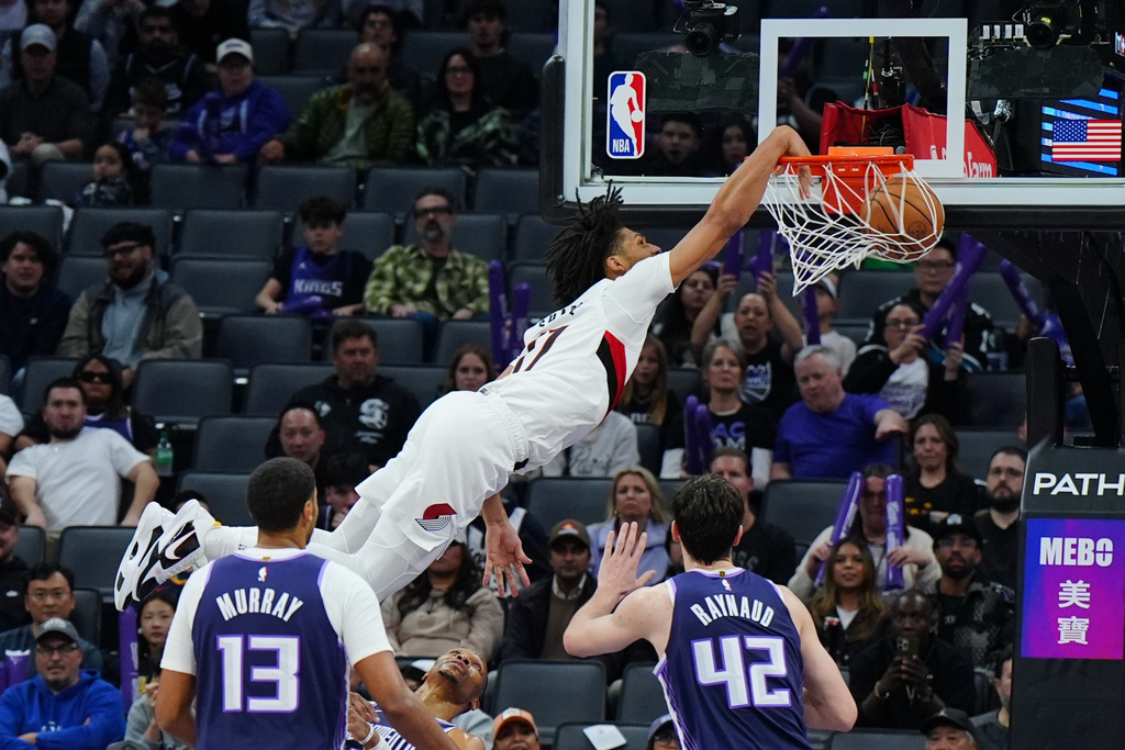 Portland Trail Blazers guard Shaedon Sharpe (17) dunks the ball during the second half of an NBA basketball game against the Sacramento Kings, Saturday, Dec. 20, 2025, in Sacramento, Calif. (AP Photo/Alan Greth)