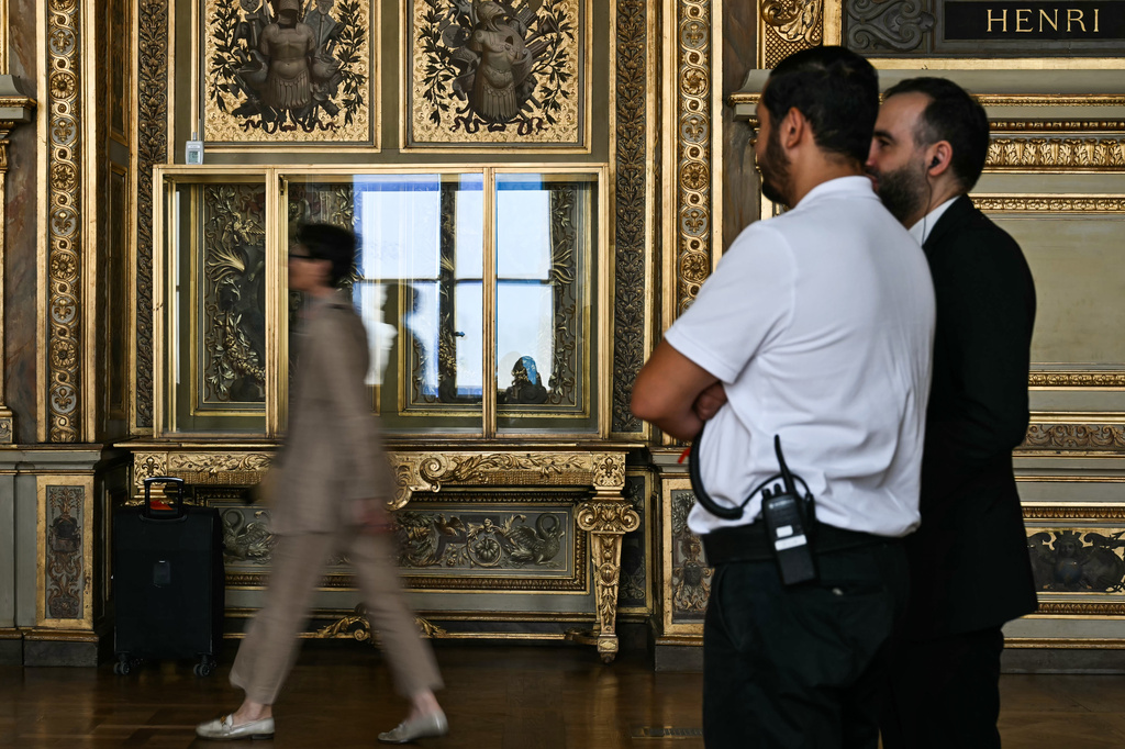 Visitors arrive during the reopening to the public of the Apollo Gallery, at the Louvre museum in Paris, Wednesday, July 22, 2026. (Lou Benoist/Pool Photo via AP)