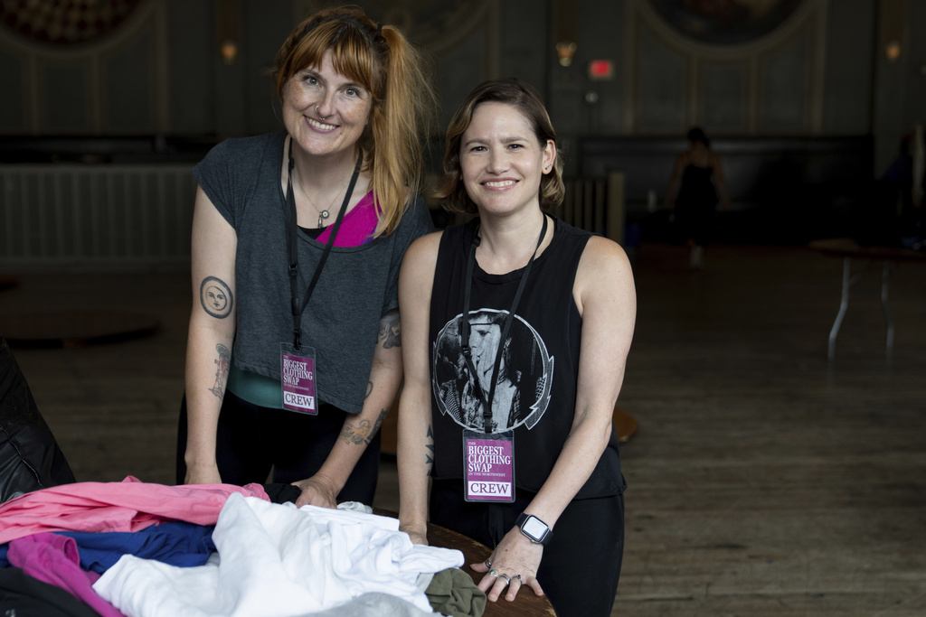 Cassie Ridgway, left, and Elizabeth Mollo pose for a photo during a clothing swap on Sunday, Sept. 14, 2025, in Portland, Ore. (AP Photo/Jenny Kane)