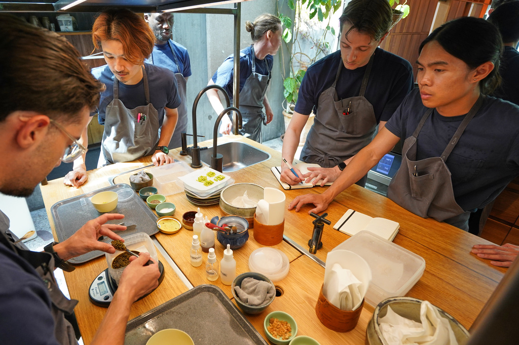 Chefs busily practice making dishes in fine-dining restaurant Noma's kitchen ahead of its new season in Copenhagen, Denmark Tuesday, July 28, 2026. (AP Photo/James Brooks)