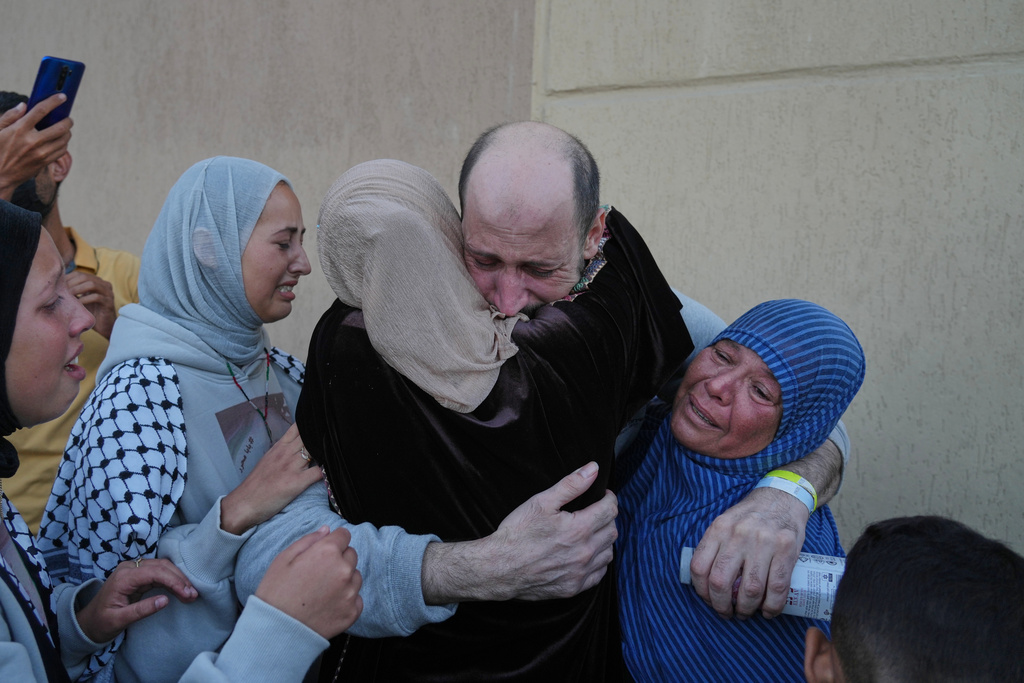 A freed Palestinian prisoner is welcomed by relatives upon arriving in the Gaza Strip after being released from Israeli jails under a ceasefire agreement between Hamas and Israel, in Khan Younis, southern Gaza Strip, Monday, Oct. 13, 2025. (AP Photo/Jehad Alshrafi)