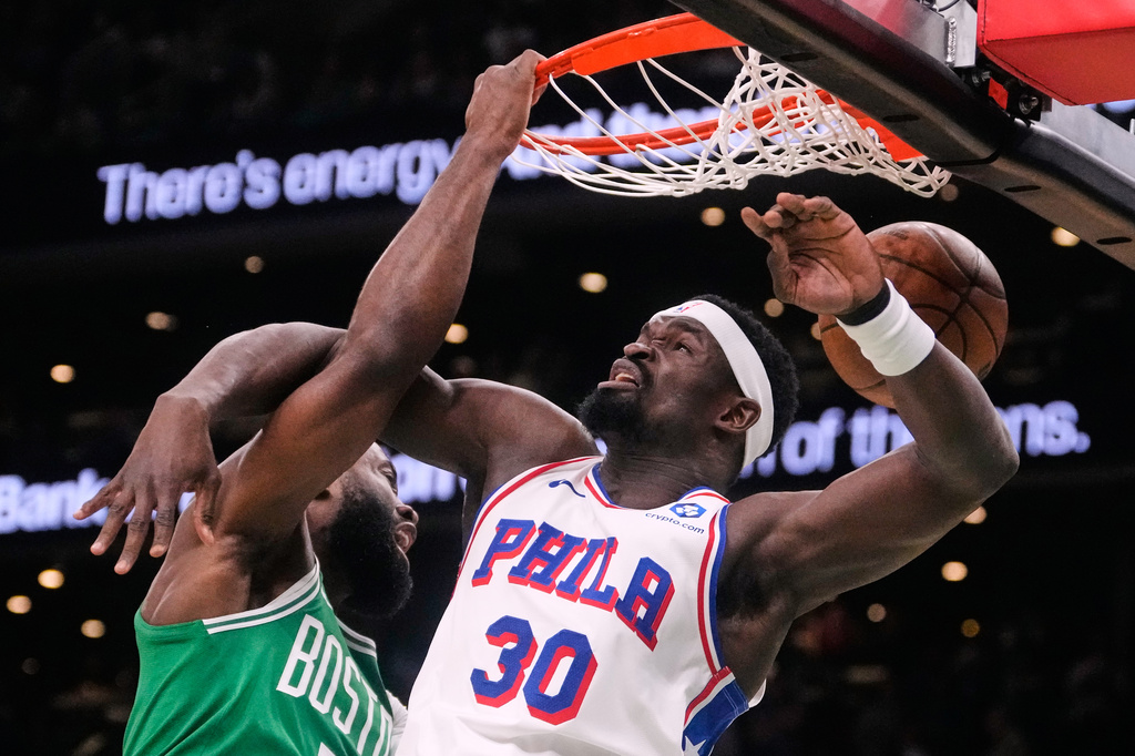 Boston Celtics guard Jaylen Brown (7) slams a dunk against Philadelphia 76ers center Adem Bona (30) during the first half of Game 2 of a first-round NBA playoffs basketball game, Tuesday, April 21, 2026, in Boston. (AP Photo/Charles Krupa)