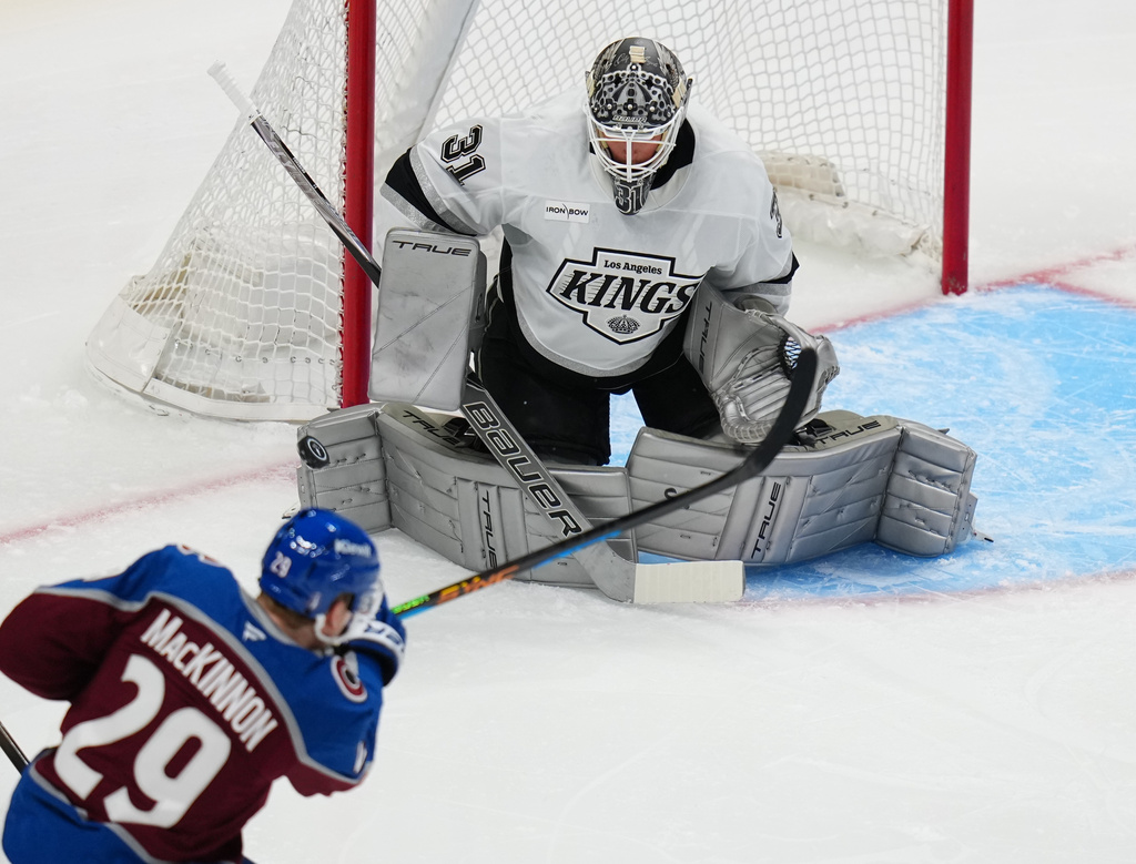 Los Angeles Kings goaltender Anton Forsberg (31) blocks a shot by Colorado Avalanche center Nathan MacKinnon (29) during the first period of Game 2 in the first round of the NHL hockey Stanley Cup playoffs, Tuesday, April 21, 2026, in Denver. (AP Photo/Jack Dempsey)