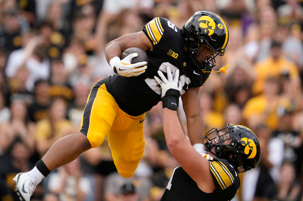 Iowa running back Xavier Williams, left, celebrates with teammate offensive lineman Jack Dotzler after scoring a touchdown during the first half of an NCAA college football game against Northern Iowa in Iowa City, Iowa, Saturday, Sept. 19, 2026. (AP Photo/Charlie Neibergall)