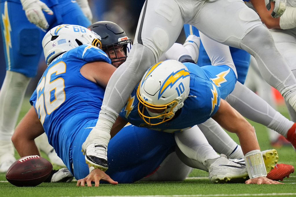 Los Angeles Chargers quarterback Justin Herbert (10) fumbles the ball during the second half of an NFL football game against the Denver Broncos, Sunday, Oct. 11, 2026, in Inglewood, Calif. (AP Photo/Gregory Bull)