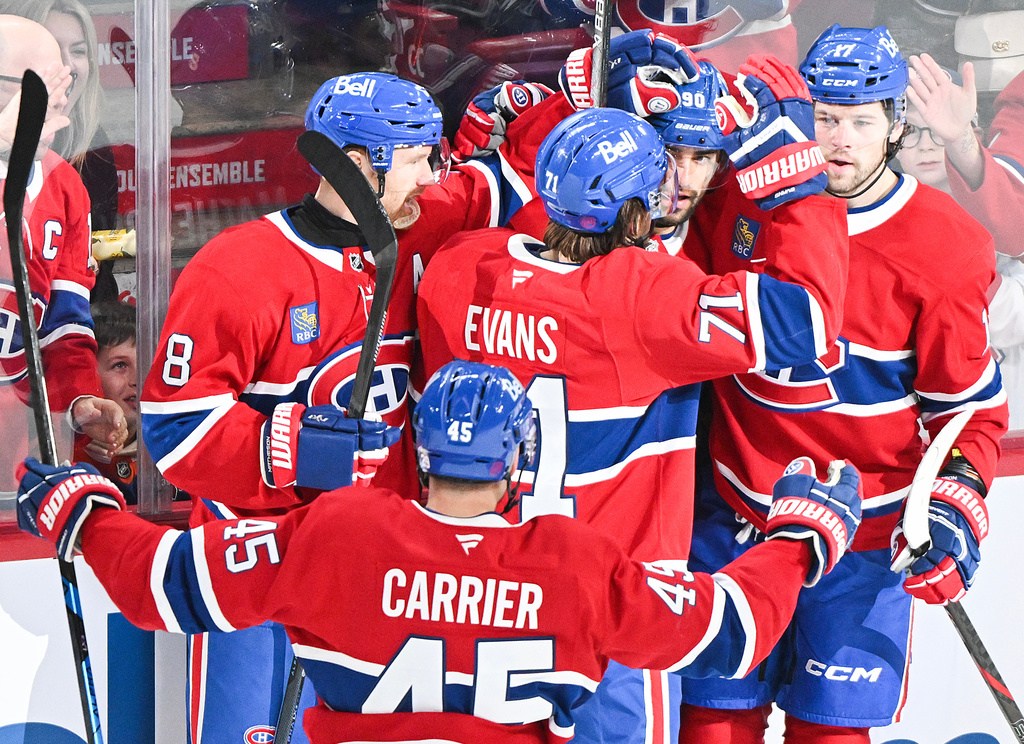 Montreal Canadiens' Joseph Veleno (90) celebrates with teammates Mike Matheson (8), Alexandre Carrier (45), Jake Evans (71) and Josh Anderson (17) after scoring against the Edmonton Oilers during second-period NHL hockey game action in Montreal, Sunday, Dec. 14, 2025. (Graham Hughes/The Canadian Press via AP)
