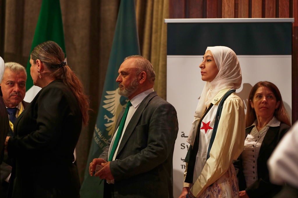 Syrian electoral college members line up to cast their ballots in a parliamentary election at a polling station in Damascus, Syria, Sunday, Oct. 5, 2025. (AP Photo/Omar Sanadiki)