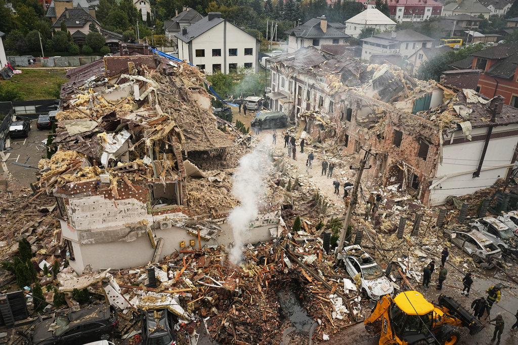 Rescuers work at the site of an apartment buildings damaged during a Russian attack in Kyiv, Ukraine, Sunday, Sept. 28, 2025. (AP Photo/Efrem Lukatsky)