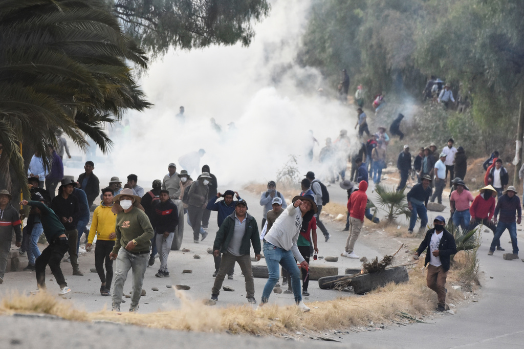 Anti-government protesters blocking a highway sling stones at military police during clashes in Vinto, Bolivia, Monday, June 8, 2026. (AP Photo/Dico Soliz)