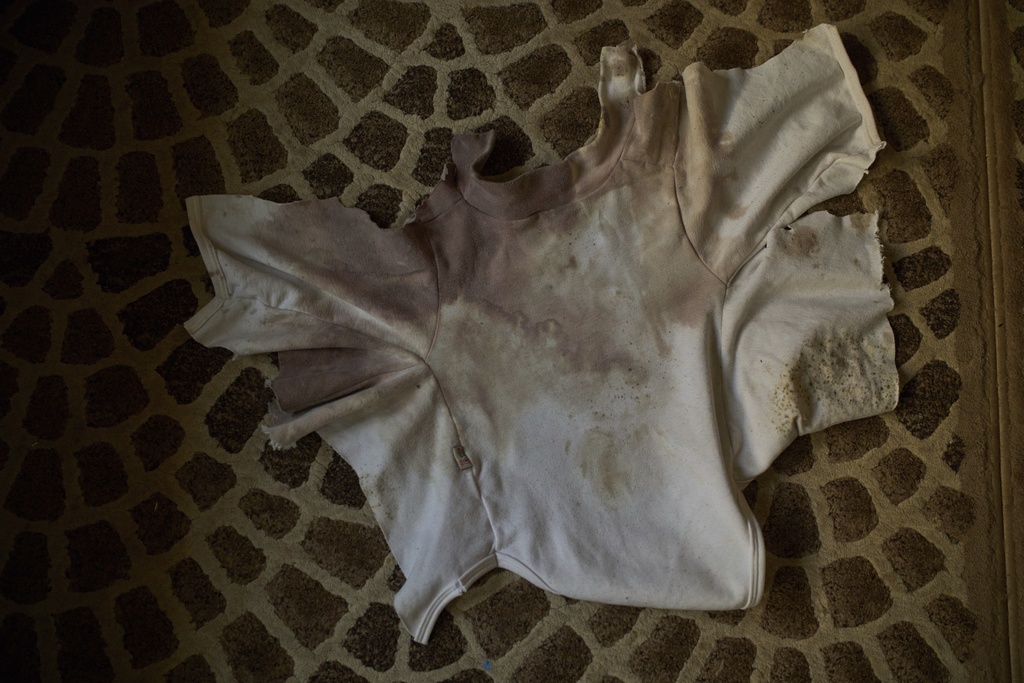 A blood-stained shirt that Tayma Asous says was worn by her 2-year-old daughter, Layla Al-Khatib, when she was shot in the head by Israeli gunfire, is laid out at their home in the village of Muthallath ash-Shuhada, near the West Bank city of Jenin, March 11, 2025. (AP Photo/Leo Correa)