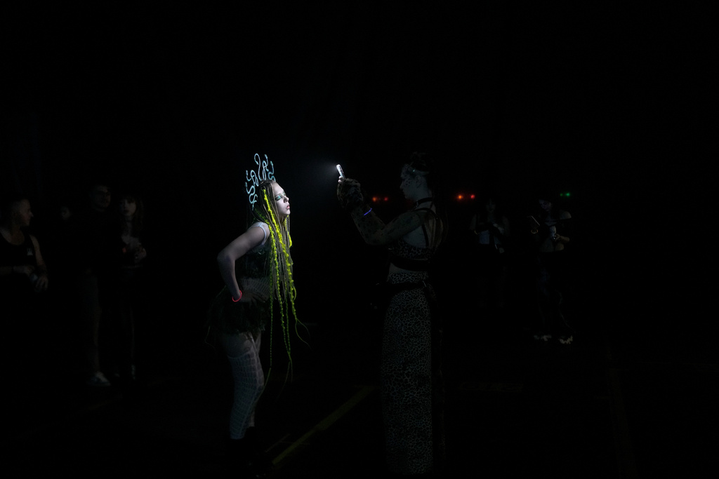 A woman donning a medusa headpiece poses for a photo during a Halloween rave in Kyiv, Ukraine, Saturday, Oct. 25, 2025. (AP Photo/Julia Demaree Nikhinson)
