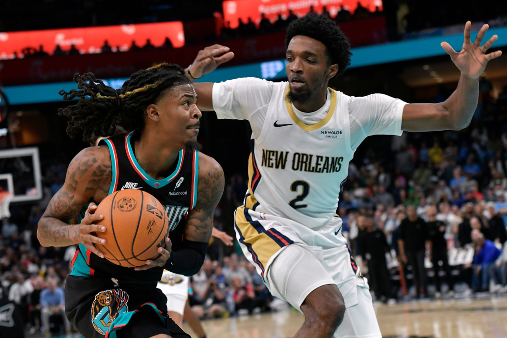 Memphis Grizzlies guard Ja Morant drives against New Orleans Pelicans forward Herbert Jones (2) in the second half of an NBA basketball game Wednesday, Oct. 22, 2025, in Memphis, Tenn. (AP Photo/Brandon Dill)