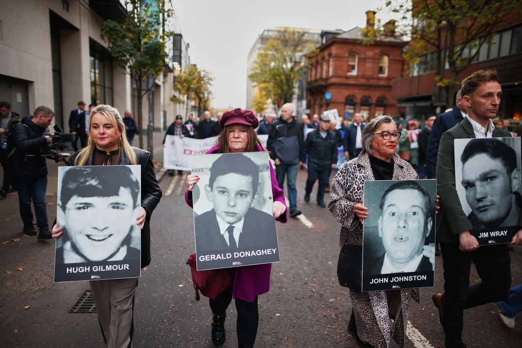 Relatives and supporters of the victims of the 1972 Bloody Sunday massacre march to Belfast Crown Court ahead of the verdict on the trial of a British soldier identified only as Soldier F, Belfast, in Northern Ireland, Thursday, Oct. 23, 2025. (AP Photo/Peter Morrison)