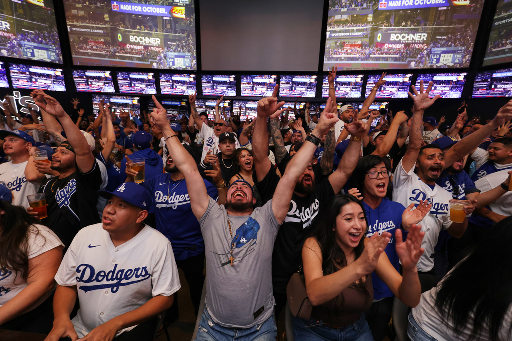 FILE - Fans react as the Los Angeles Dodgers play the Toronto Blue Jays in Game 7 of baseball's World Series at a watch party on Saturday, Nov. 1, 2025, in Los Angeles. (AP Photo/Ethan Swope, File)