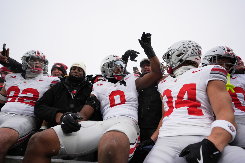 Ohio State Buckeyes defensive end Caden Curry, linebacker Sonny Styles, and wide receiver Brennen Schramm, from left, celebrate after the team's win against Michigan in an NCAA college football game, Saturday, Nov. 29, 2025, in Ann Arbor, Mich. (AP Photo/Ryan Sun)