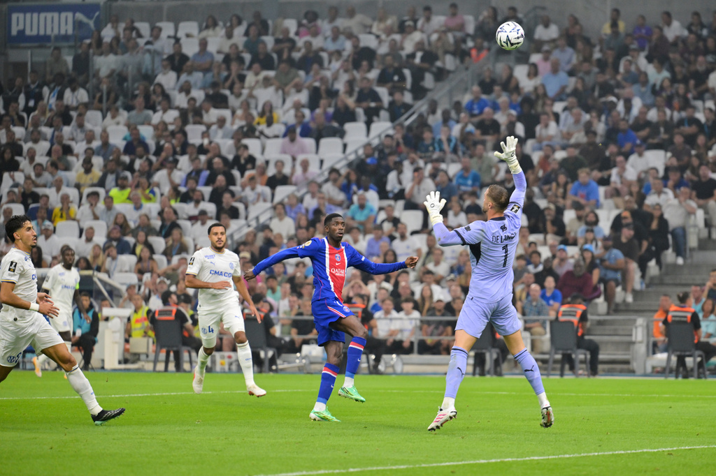 PSG's Ousmane Dembele, center, attempts a shot on goal in front of Marseille's Jeffrey De Lange during the French League One soccer match between Marseille and Paris Saint-Germain in Marseille, France, Sunday, Sept. 20, 2026. (AP Photo/Philippe Magoni)