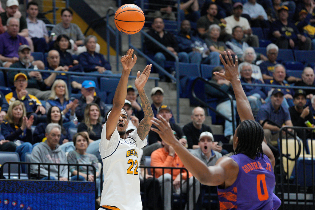 California forward Chris Bell (22) shoots a 3-point basket against Clemson forward RJ Godfrey (0) during the first half of an NCAA college basketball game in Berkeley, Calif., Saturday, Feb. 7, 2026. (AP Photo/Tony Avelar)