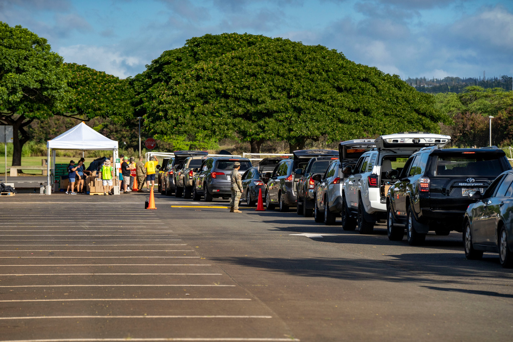 Cars line up for a Hawaii Foodbank pop-up food distribution at Waipio Soccer Complex, Monday, Nov. 10, 2025, in Waipahu, in Honolulu County, Hawaii. (AP Photo/Mengshin Lin)