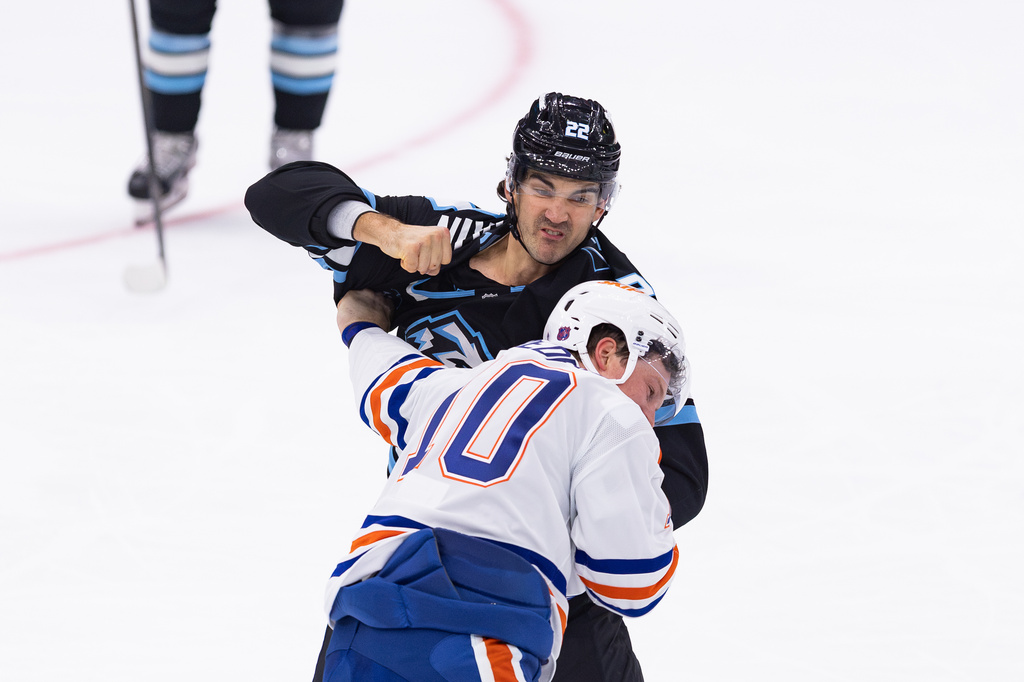 Utah Mammoth center Jack McBain (22) fights with Edmonton Oilers center Trent Frederic (10) during the first period of an NHL hockey game Saturday, Oct. 17, 2026, in Salt Lake City. (AP Photo/Melissa Majchrzak)