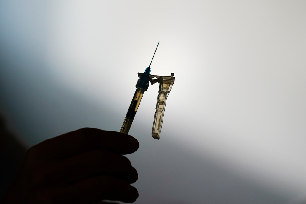 FILE - A syringe is prepared at a clinic in Norristown, Pa., on Dec. 7, 2021. (AP Photo/Matt Rourke, File)