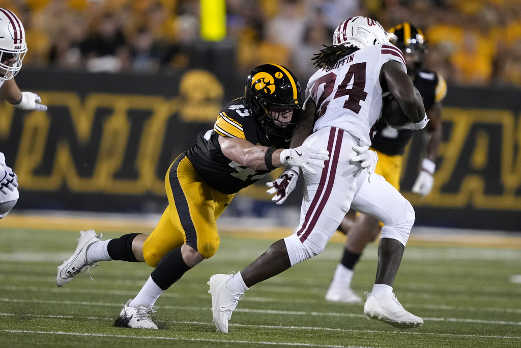 Iowa linebacker Karson Sharar (43) tackles Massachusetts running back Rocko Griffin (24) during the first half of an NCAA college football game, Saturday, Sept. 13, 2025, in Iowa City, Iowa. (AP Photo/Charlie Neibergall)