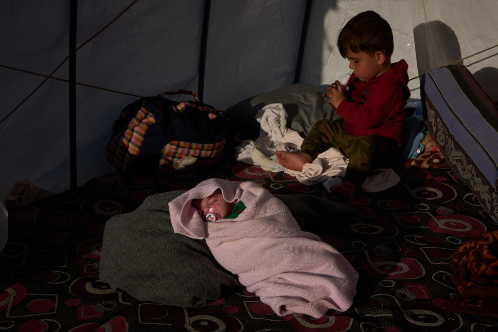 Alongside her brother Khalid, 15-day-old Shaiman sleeps in the tent where she was born, which the family is using as a shelter in Beirut, Sunday, April 12, 2026. (AP Photo/Emilio Morenatti)
