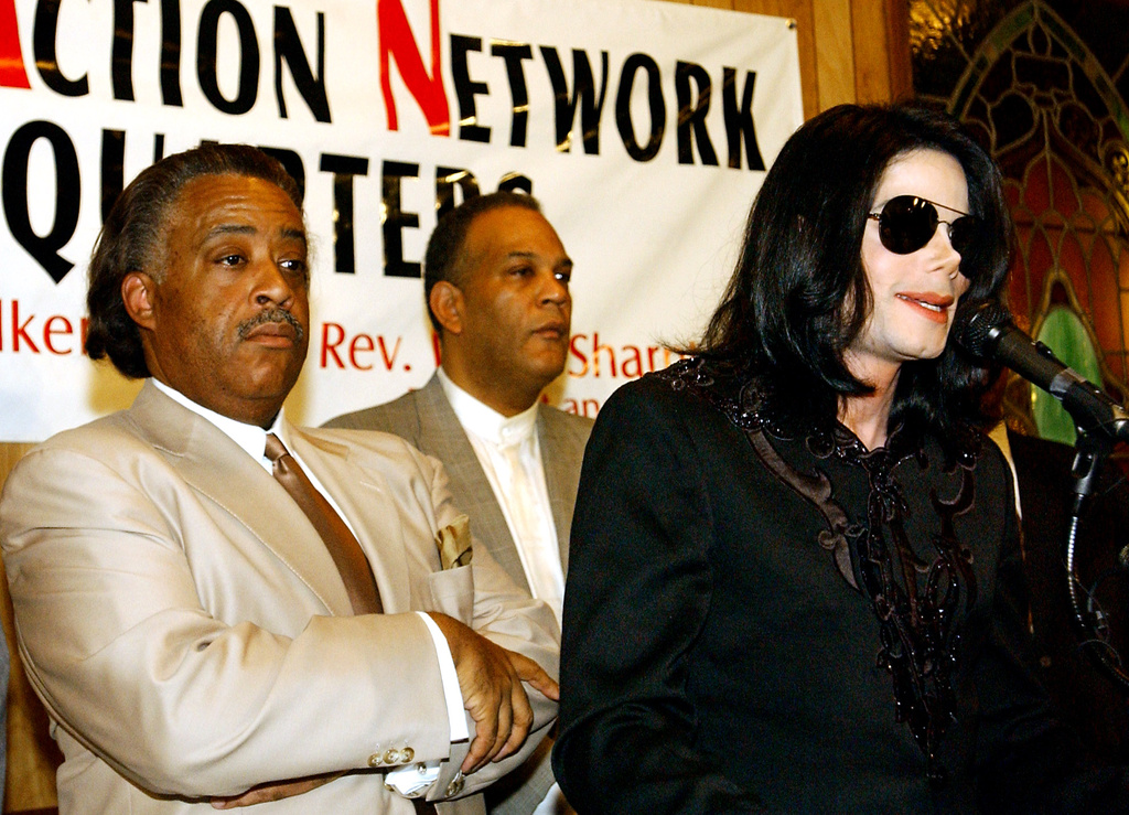 FILE - Singer Michael Jackson, right, speaks to the crowd at Rev. Al Sharpton's National Action Network headquarters, Saturday, July 6, 2002 in Harlem, New York, as Rev. Sharpton, left, listens. (AP Photo/Stephen Chernin, File)