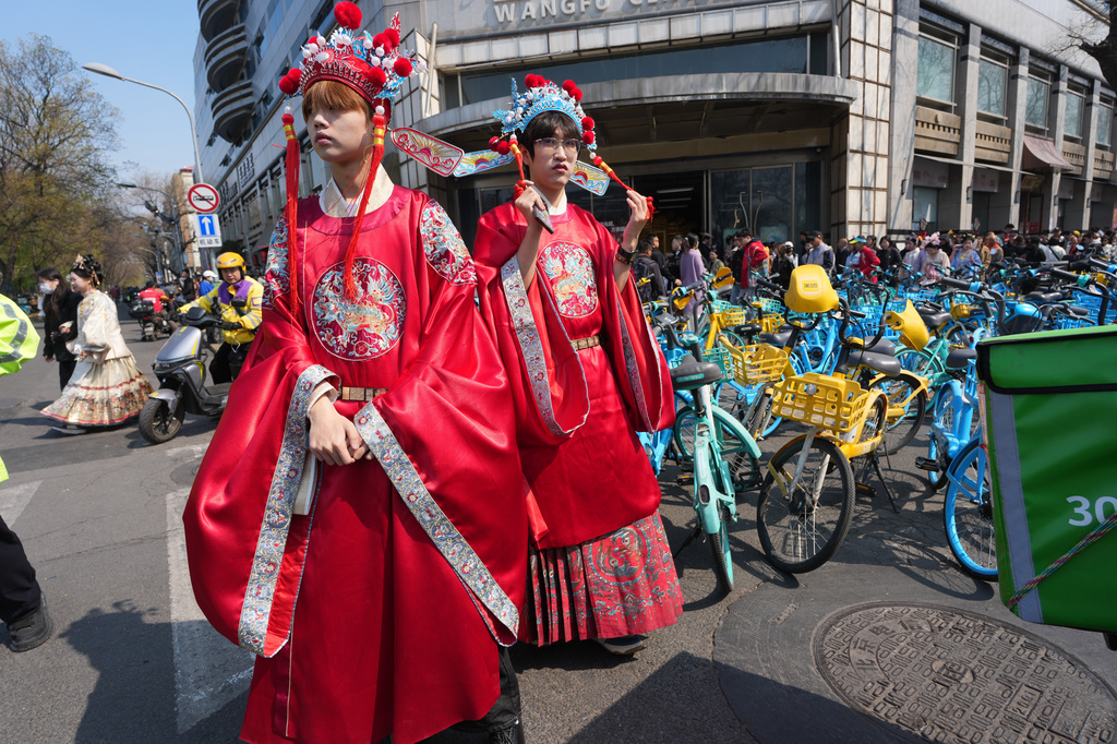 Men wear historical Chinese costumes near the Forbidden City in Beijing on Saturday, April 4, 2026. (AP Photo/Ng Han Guan)