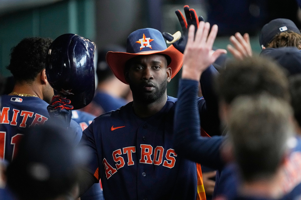 Houston Astros designated hitter Yordan Alvarez celebrates in the dugout after hitting a home run during the eighth inning of a baseball game against the St. Louis Cardinals in Houston, Sunday, April 19, 2026. (AP Photo/Ashley Landis)