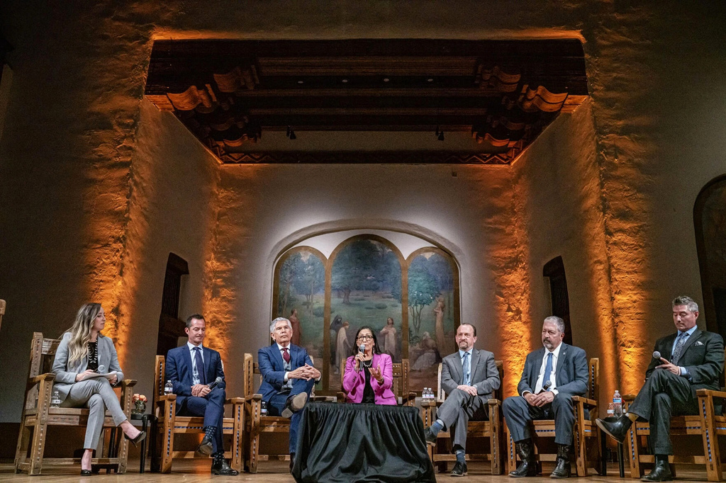 Gubernatorial candidates, from second left, Doug Turner, Duke Rodriguez, Deb Haaland, Gregg Hull and Sam Bregman answer questions from moderators Rikki-Lee Chavez, left, and Matthew Jaramillo, right, during a forum, April 22, 2026, in Santa Fe, N.M. (Gabriela Campos/Santa Fe New Mexican via AP)