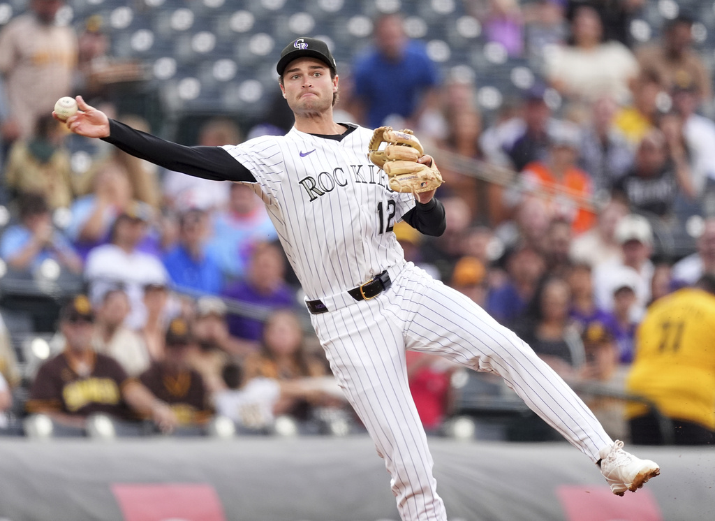 Colorado Rockies third baseman Kyle Karros throws to first base to put out San Diego Padres' Manny Machado to end the top of the first inning of a baseball game Saturday, Sept. 6, 2025, in Denver. (AP Photo/David Zalubowski)