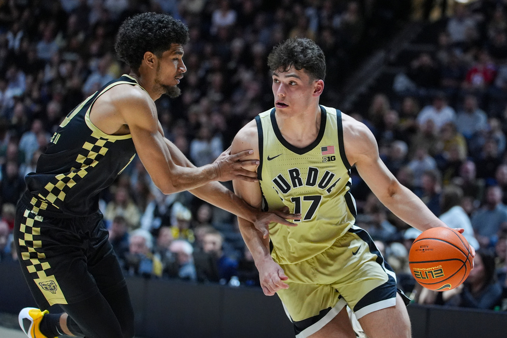Purdue guard Omer Mayer (17) drives on Oakland guard Brett White II (10) during the second half of an NCAA college basketball game in West Lafayette, Ind., Friday, Nov. 7, 2025. (AP Photo/Michael Conroy)