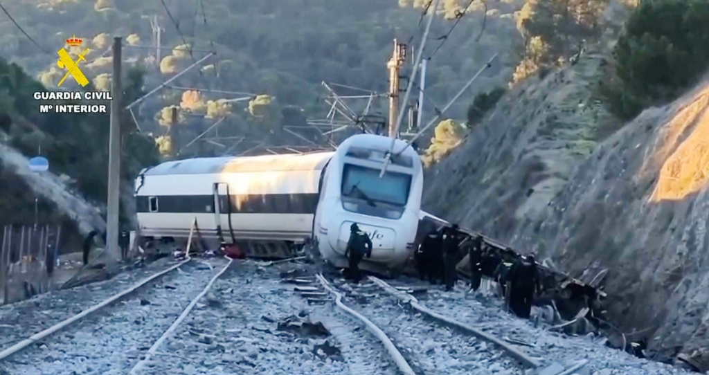 In this grab taken from video provided by Guardia Civil, rescue workers at the scene after a high speed train collision, in Adamuz, Spain, Monday, Jan. 19, 2026. (Guardia Civil via AP)
