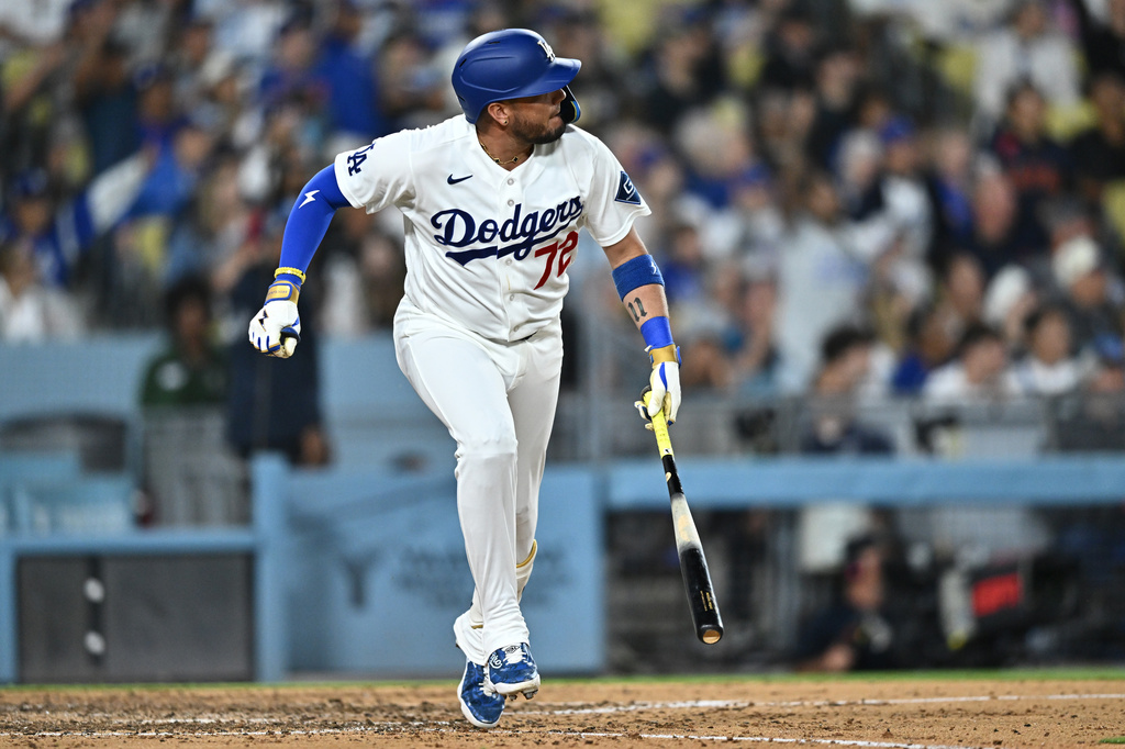 Los Angeles Dodgers' Miguel Rojas watches his home run during the seventh inning of a baseball game against the Tampa Bay Rays, Monday, June 15, 2026, in Los Angeles. (AP Photo/William Liang)