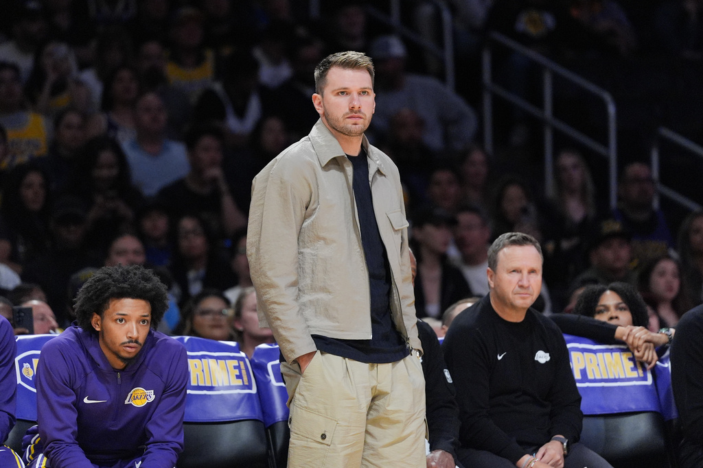 Los Angeles Lakers' Luka Doncic watches action during the first half of a preseason NBA basketball game against the Golden State Warriors Sunday, Oct. 12, 2025, in Los Angeles. (AP Photo/Jae C. Hong)