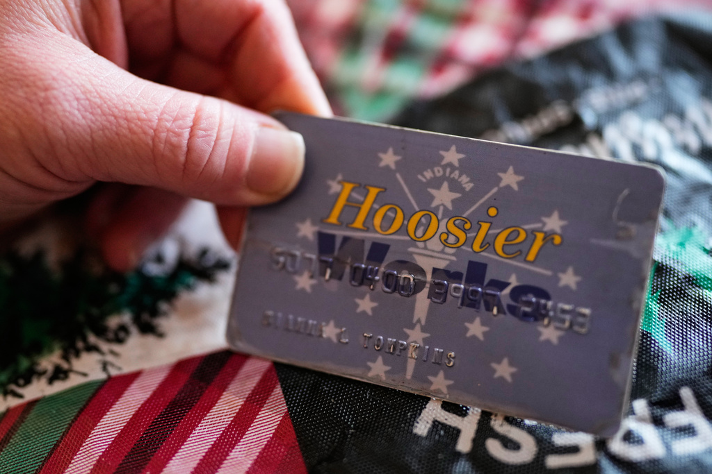 Dianna Tompkins holds a her SNAP card at home in Demotte, Ind., Dec. 17, 2025. (AP Photo/Nam Y. Huh)