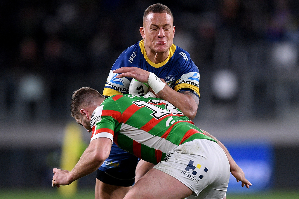 Kane Evans of the Parramatta Eels, top, is tackled by Bayley Sironen of the South Sydney Rabbitohs during their National Rugby League match between in Sydney, on Aug. 27, 2020. (Dan Himbrechts/AAP Image via AP)