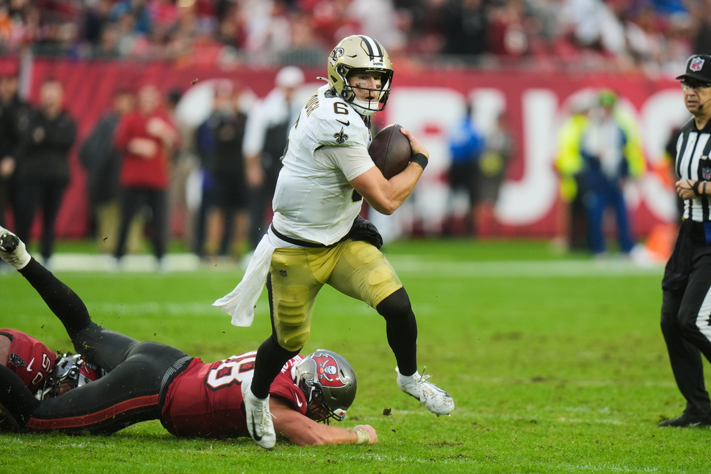 New Orleans Saints quarterback Tyler Shough (6) carries for a touchdown past Tampa Bay Buccaneers safety Rashad Wisdom (38) in the second half of an NFL football game, Sunday, Dec. 7, 2025, in Tampa, Fla. (AP Photo/Chris O'Meara)