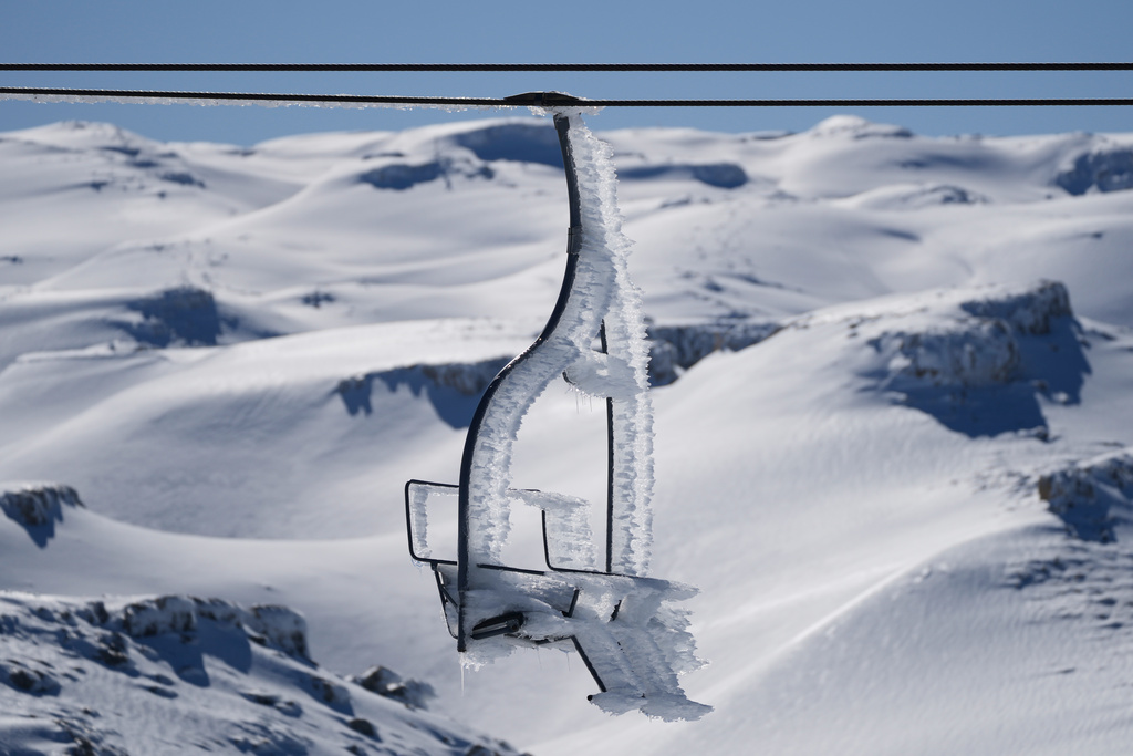 A chairlift is coated in ice from freezing winds at the Mzaar-Kfardebian ski resort northeast of Beirut, Lebanon, Saturday, Jan. 3, 2026. (AP Photo/Hassan Ammar)