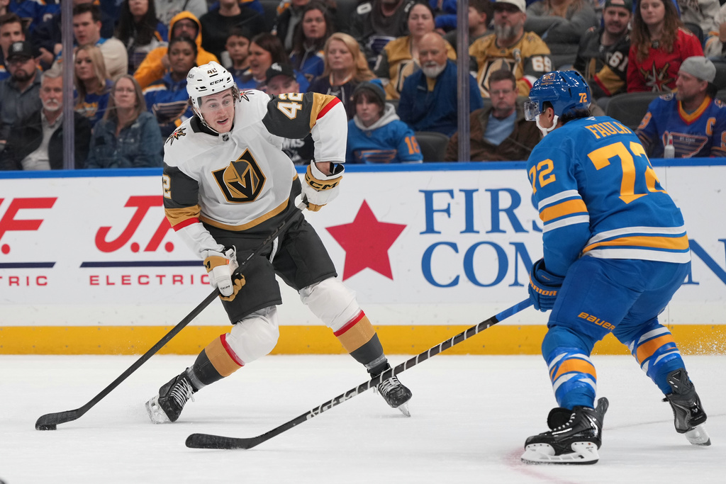 Vegas Golden Knights' Braeden Bowman (42) shoots past St. Louis Blues' Justin Faulk (72) during the first period of an NHL hockey game Saturday, Nov. 15, 2025, in St. Louis. (AP Photo/Jeff Roberson)