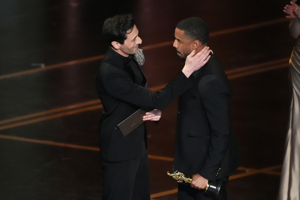 Adrien Brody, left, presents the award for best actor in a leading role to Michael B. Jordan for "Sinners" during the Oscars on Sunday, March 15, 2026, at the Dolby Theatre in Los Angeles. (AP Photo/Chris Pizzello)