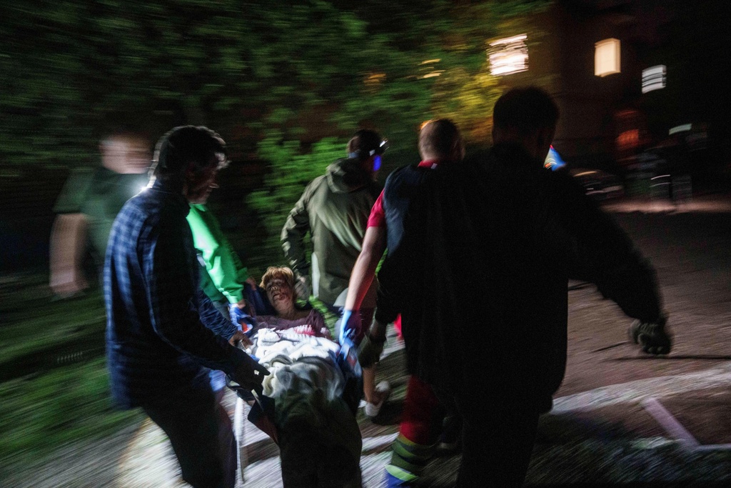 FILE - Rescue workers carry an injured woman on a stretcher out of a house destroyed by a Russian airstrike in a residential neighbourhood in Kyiv, Ukraine, on Thursday, April 24, 2025. (AP Photo/Evgeniy Maloletka, File)