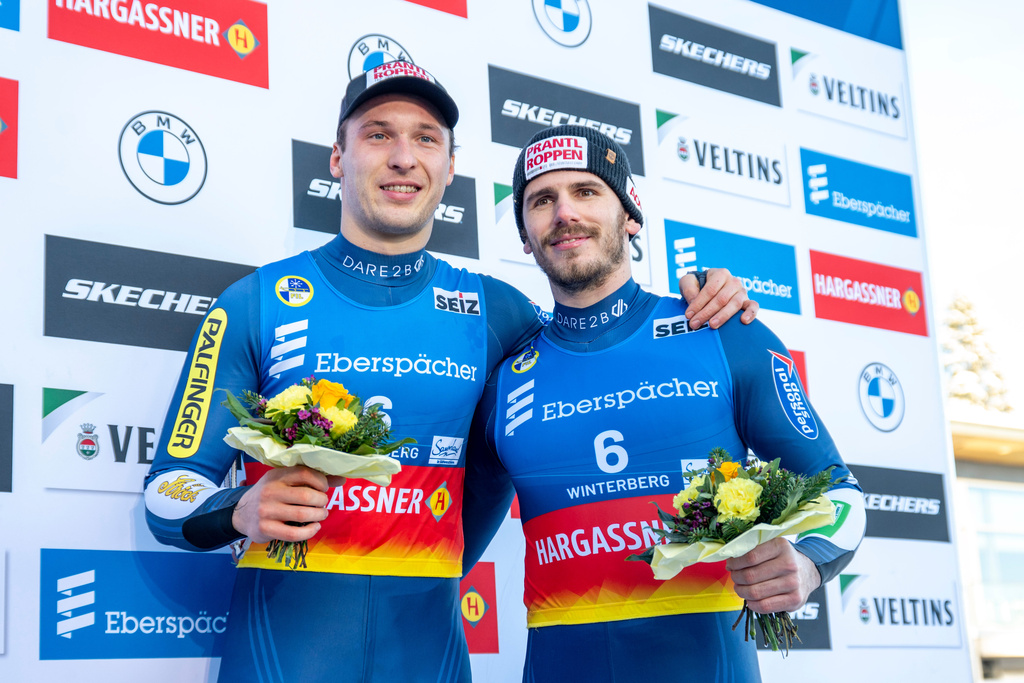 Juri Thomas Gatt, left, and Riccardo Schöpf of Austria celebrate their third place in the doubles men competition of the Luge World Cup in Winterberg, Germany, Sunday Jan. 11, 2026. (David Inderlied/dpa via AP)