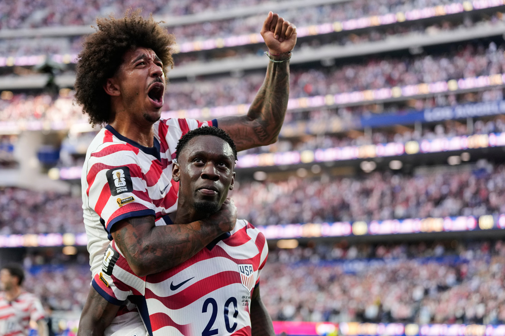 United States' Folarin Balogun (20) celebrates scoring his side's third goal against Paraguay with teamate Chris Richards during the World Cup Group D soccer match in Inglewood, Calif., near Los Angeles, Friday, June 12, 2026. (AP Photo/Andre Penner)