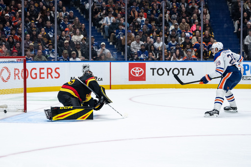 Edmonton Oilers' Leon Draisaitl (29), scores on Vancouver Canucks goaltender Thatcher Demko (35) during second period NHL hockey action in Vancouver, British Columbia, Sunday, Oct. 26, 2025. (Ethan Cairns/The Canadian Press via AP) Edmonton Oilers' Leon Draisaitl (29), scores on Vancouver Canucks goaltender Thatcher Demko (35) during second period NHL hockey action in Vancouver, British Columbia, Sunday, Oct. 26, 2025. (Ethan Cairns/The Canadian Press via AP)