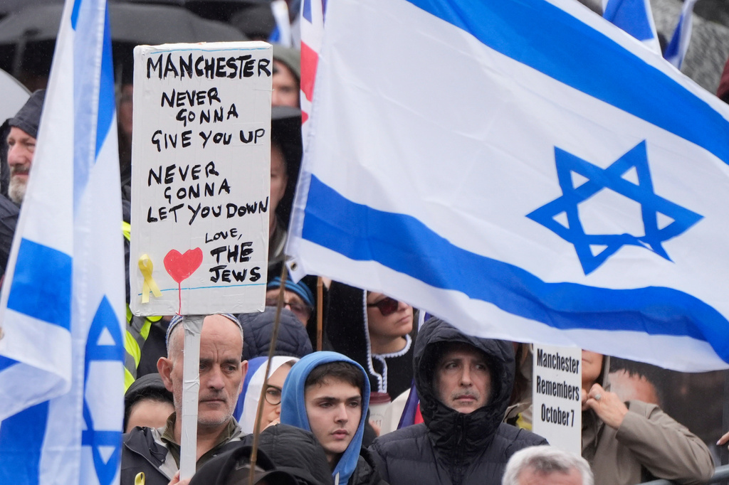 People attend a protest outside Manchester Cathedral following an attack at Heaton Park Hebrew Congregation synagogue in Crumpsall, where two people died, in Manchester, England, Sunday Oct. 5, 2025. (Danny Lawson/PA via AP)