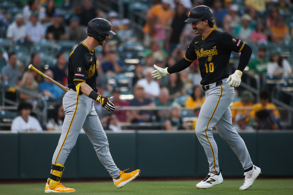 Pittsburgh Pirates' Bryan Reynolds (10) celebrates his solo home run with Ryan O'Hearn, left, during the sixth inning of a baseball game against the Athletics, Tuesday, June 16, 2026, in West Sacramento, Calif. (AP Photo/Scott Marshall)