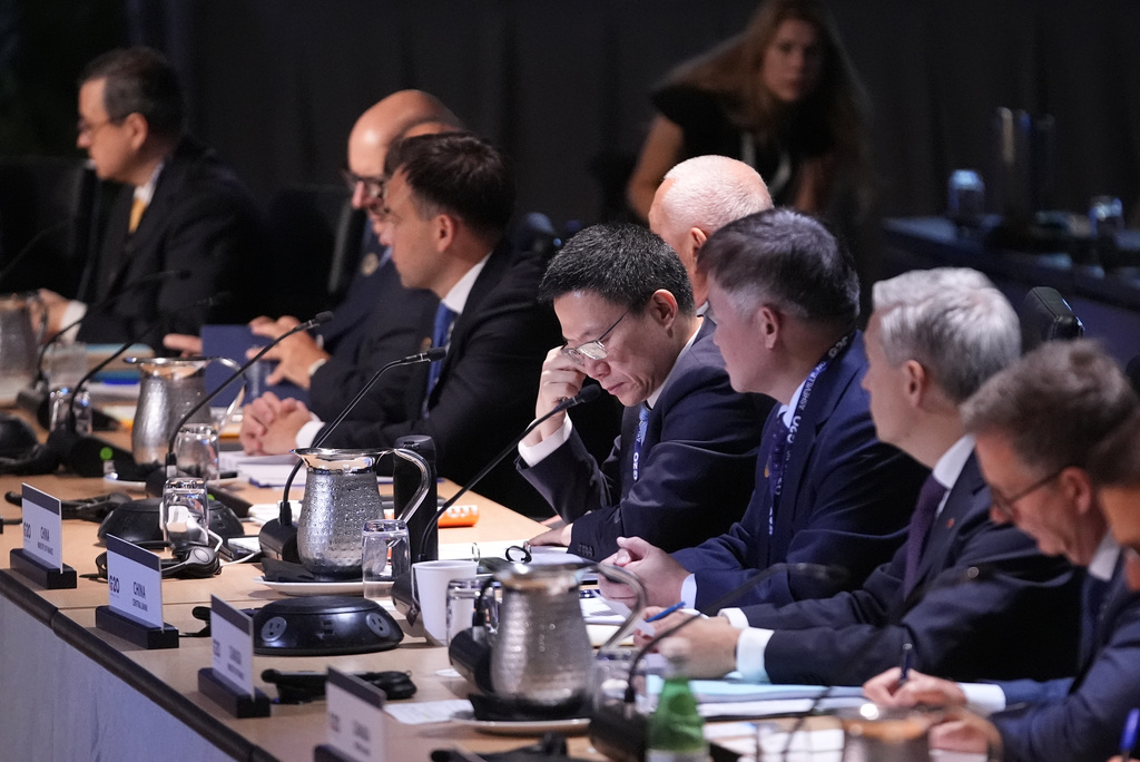 Chinese Vice Minister of Finance Liao Min, center, listens during the Plenary Session of Current Economic Developments at the G20 Finance Ministerial in Asheville, N.C., Monday, Aug. 31, 2026. (AP Photo/Gerald Herbert)
