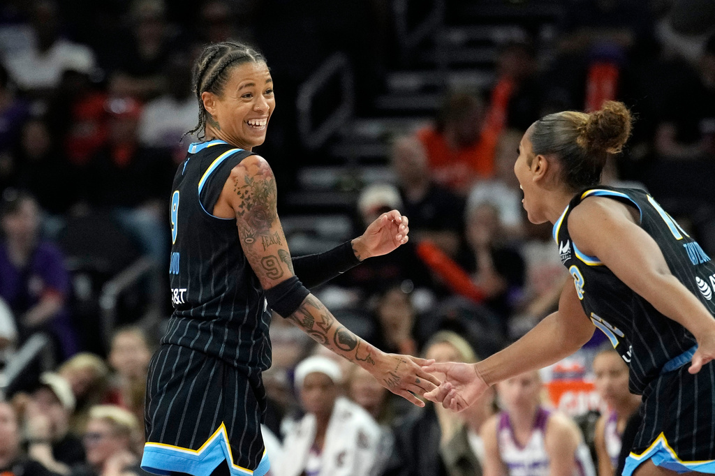 Chicago Sky guard Natasha Cloud, left, smiles while celebrating a 3-pointer against the Phoenix Mercury with Sky guard Sydney Taylor during the second half of a WNBA basketball game, Tuesday, July 7, 2026, in Phoenix. (AP Photo/Ross D. Franklin)